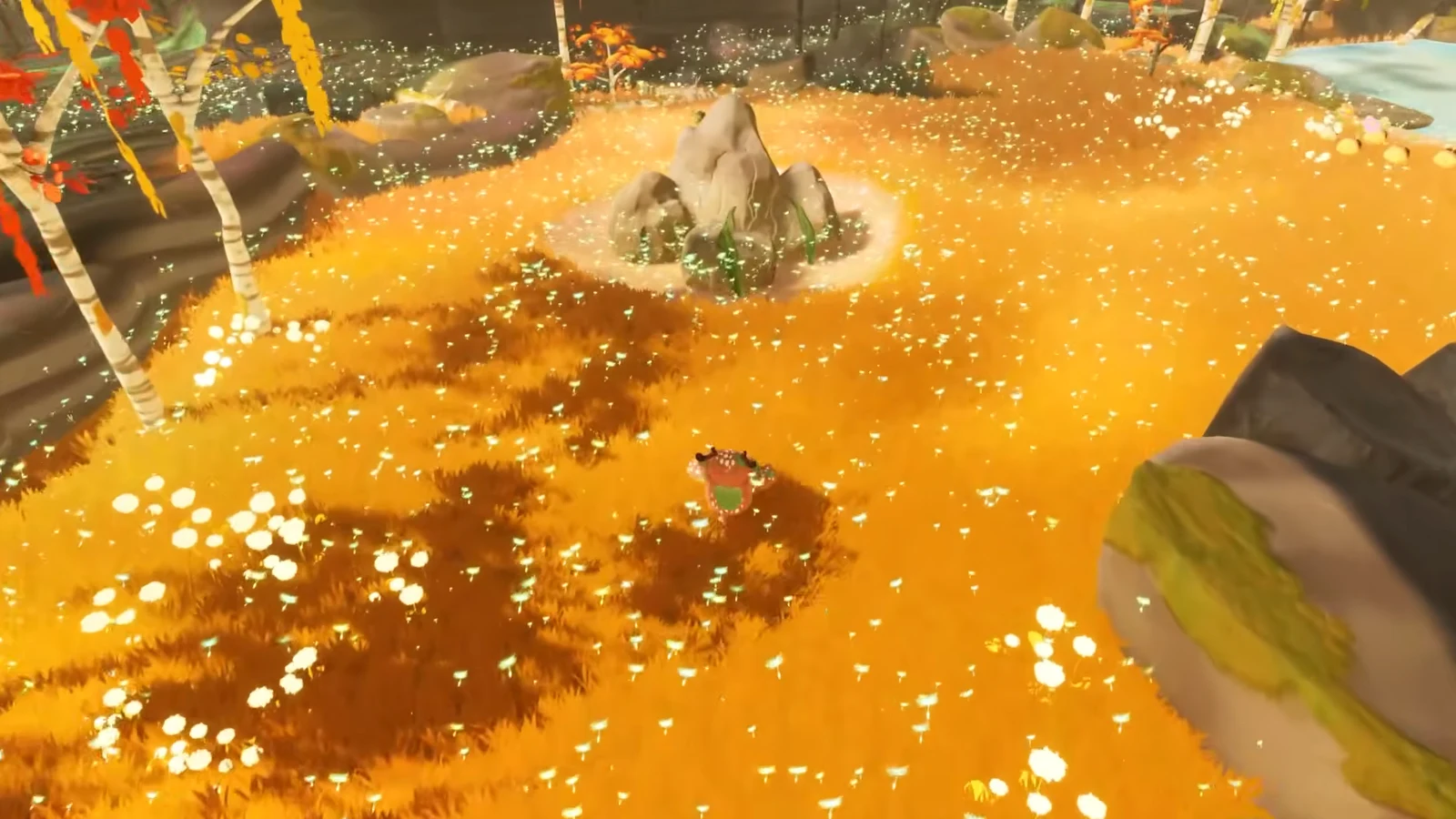 Character crossing a bright orange flower-covered field toward the central rock formation