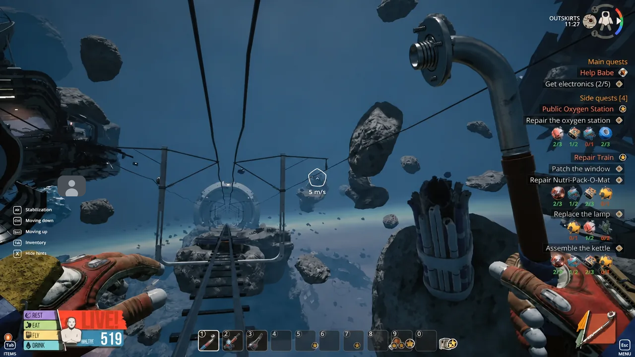 Shoes hanging from a cable in space with the Outskirts train tracks running underneath