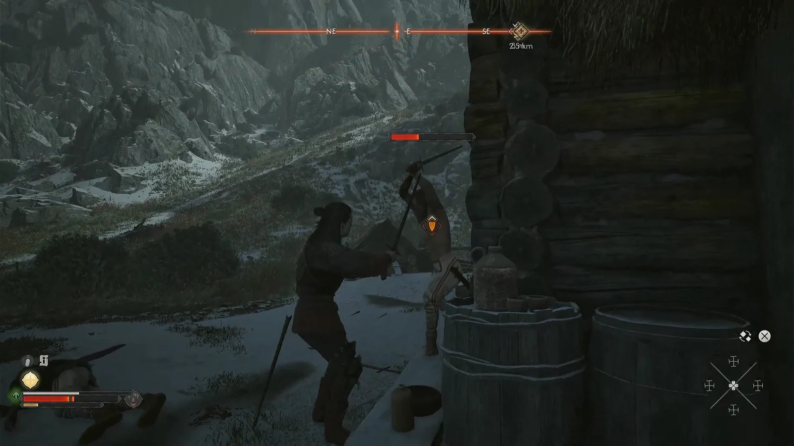 Coen swinging at a remaining camp enemy beside the wooden building