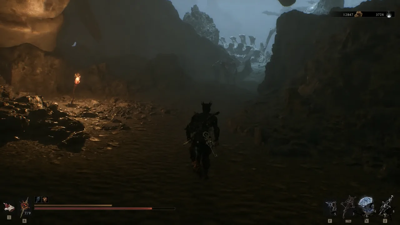 Torch-lit cave corridor inside Odious Crevice leading toward a bright opening