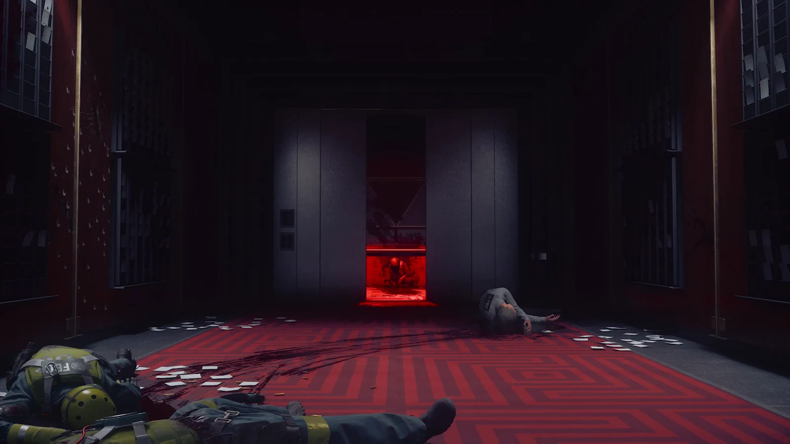 A body lies beside equipment in a red-lit industrial elevator lobby, with another body visible at right.