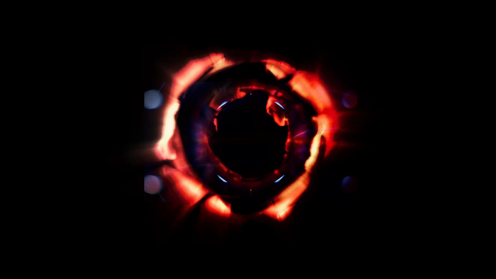A glowing red ring surrounds a dark central orb in an otherwise black void.