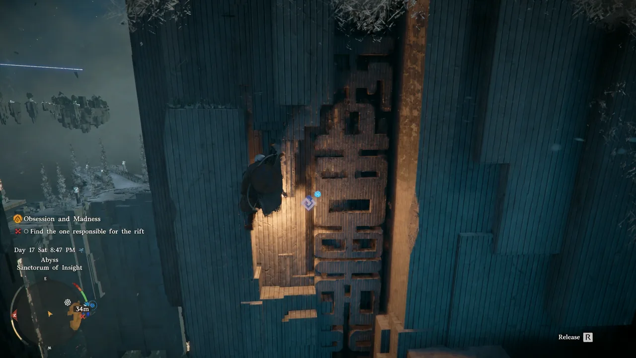 Kliff scaling the carved handholds on the vertical pillar wall with the release prompt on screen