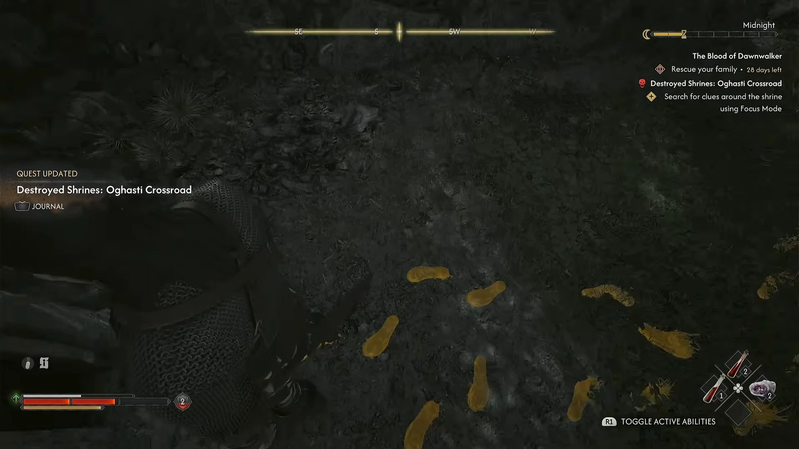 Focus Mode lighting up yellow footprints on the ground beside the wrecked roadside shrine