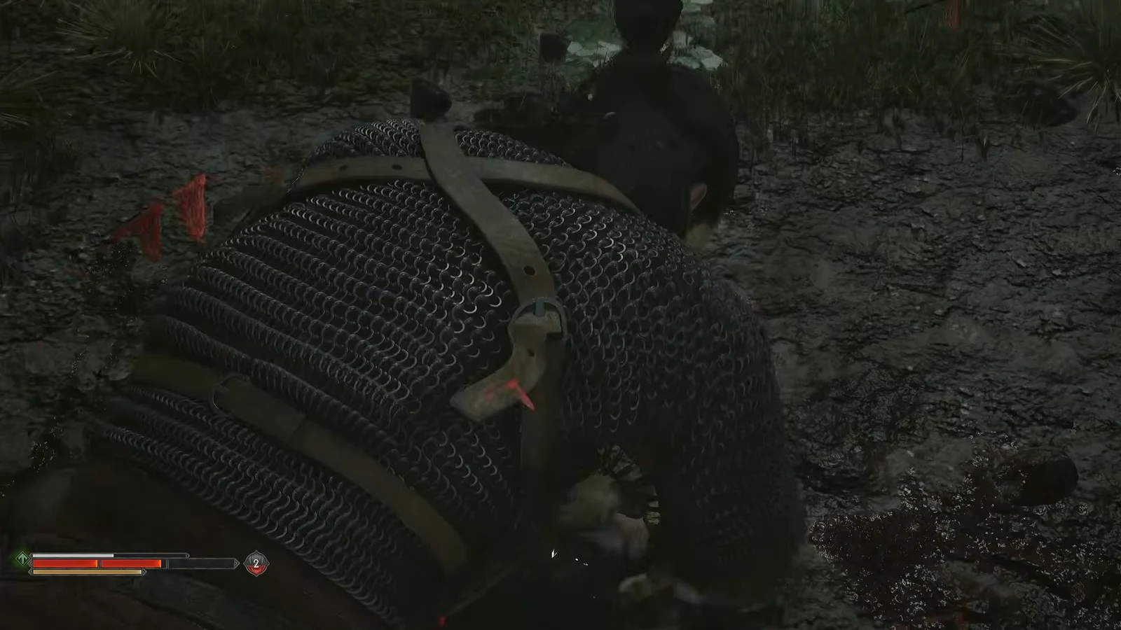 Coen in chainmail trading blows with an enemy in close quarters on muddy forest ground