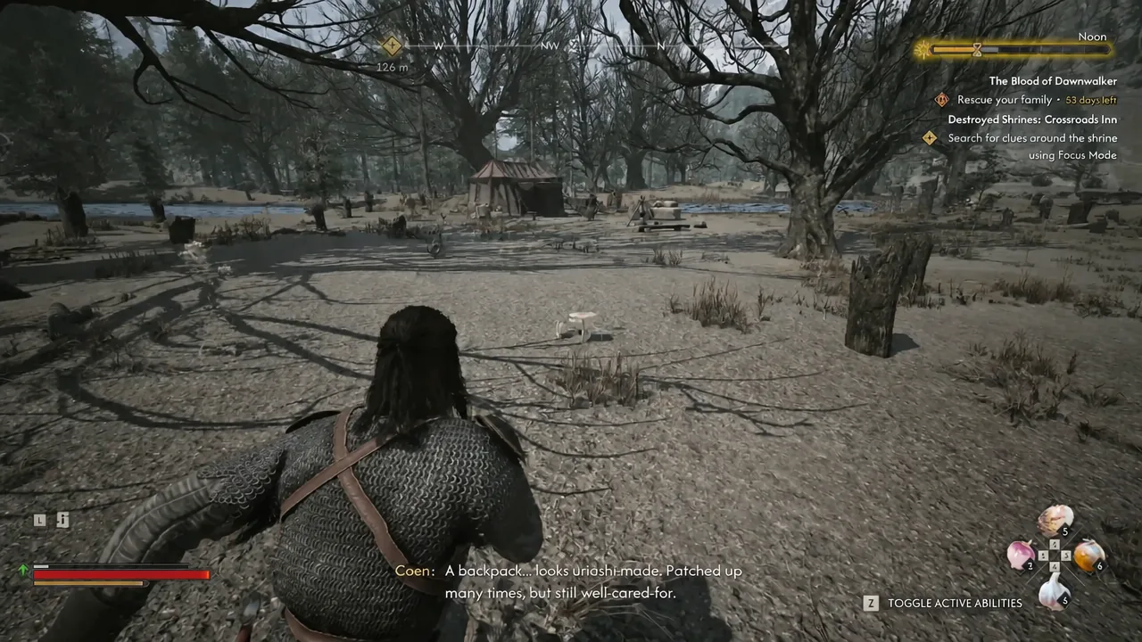 Coen examining the abandoned backpack found at the riverbank clue