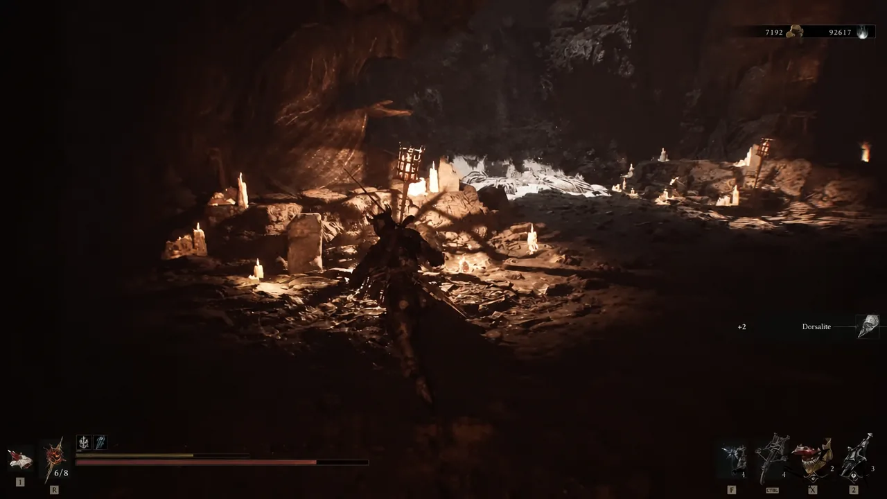 Player moving through the candlelit cavern with Dorsalite in the quick-item bar