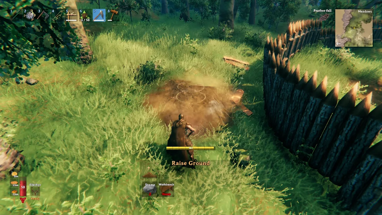Hoe equipped in hotbar slot 7 while raising ground to form a defensive earth wall