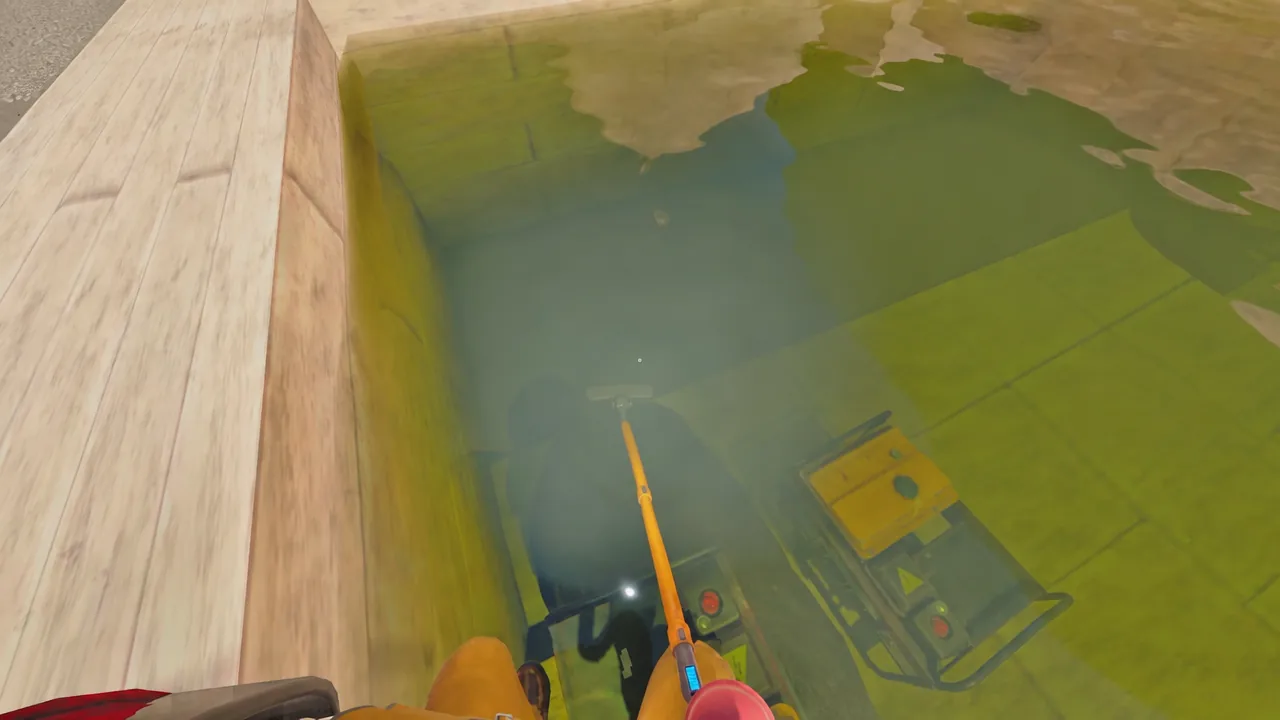 Player aiming an orange tool down at submerged equipment beside a flooded pit