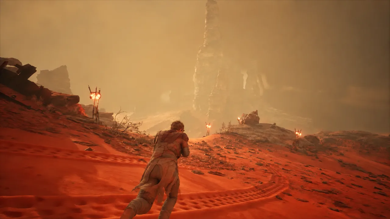 A player character pushes through a sandstorm on Arrakis before collapsing on the dunes