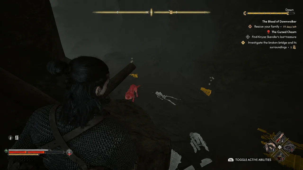 Dark chasm floor with a red enemy outline and nearby loot picked out by the highlight