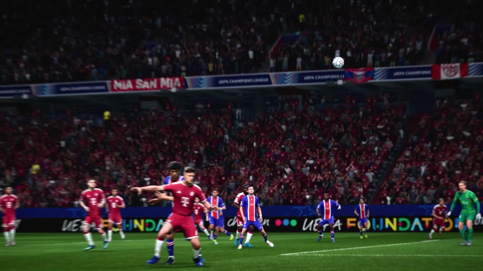Players contest the ball in a packed stadium during a nighttime match between Atlético Madrid and Roma.