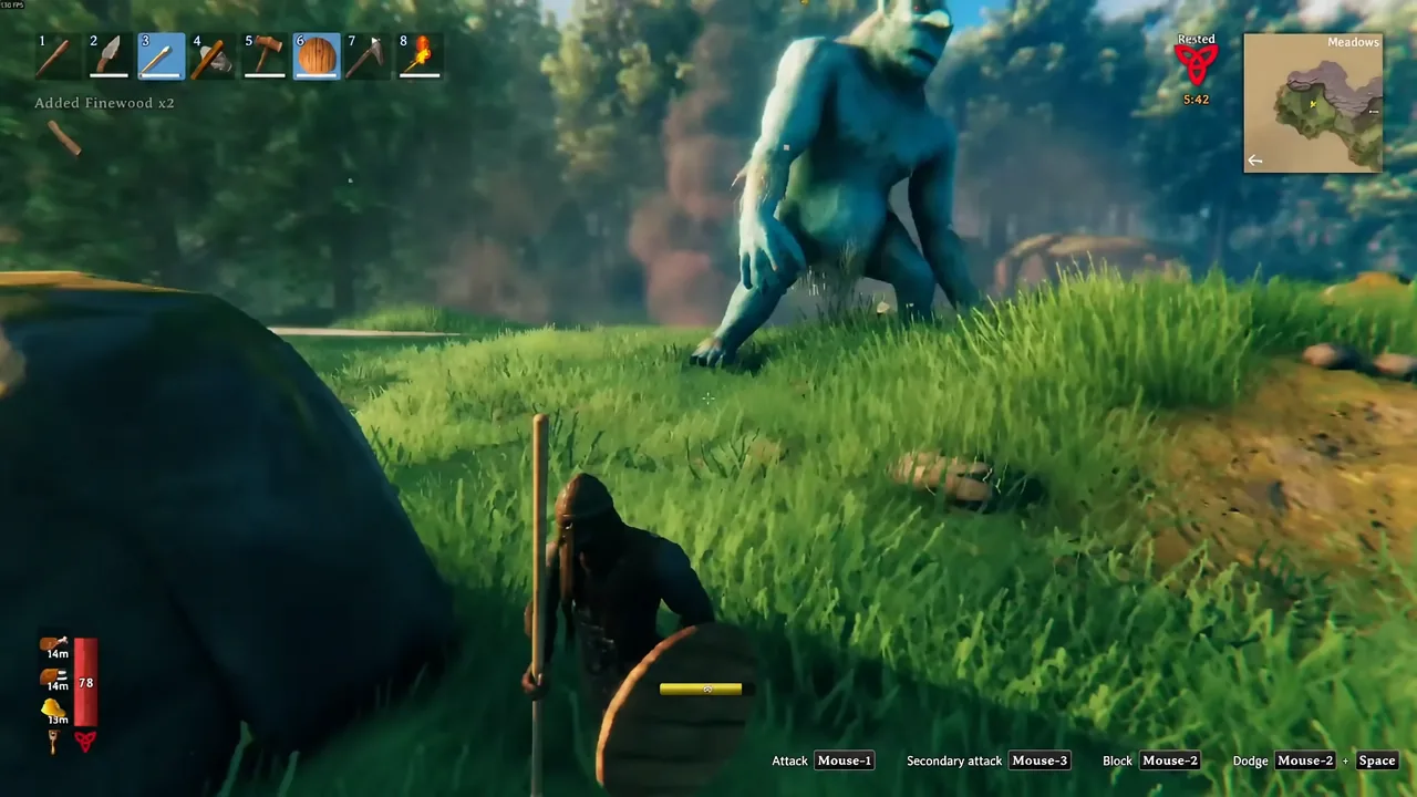 A player blocks a troll with a wooden shield equipped in hotbar slot six