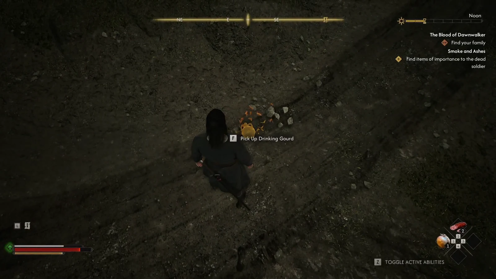 Coen holding the interact prompt to pick up the Drinking Gourd from the dirt path