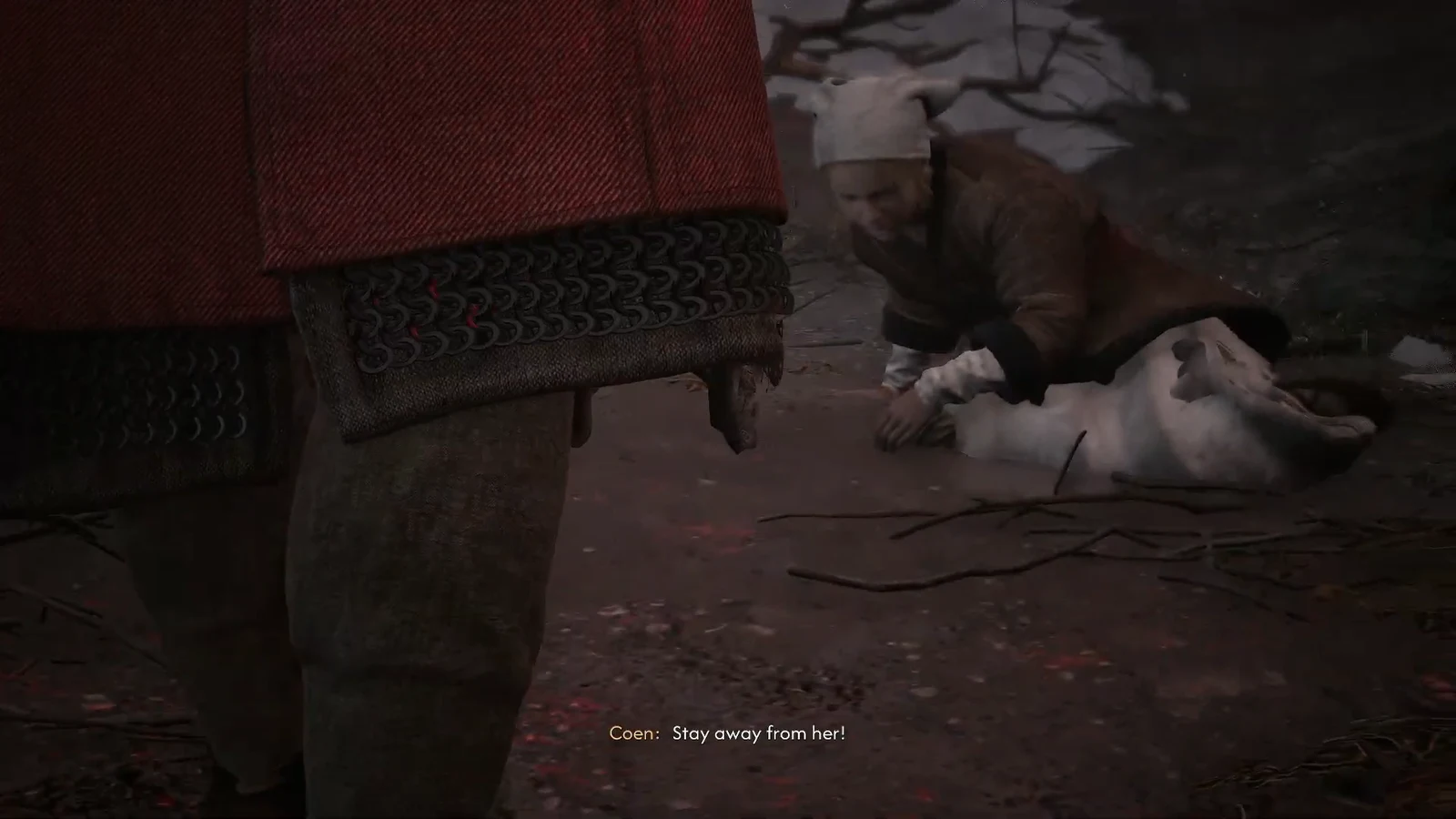 Coen kneeling in the snow beside an injured pale figure as a soldier shouts Stay away from her