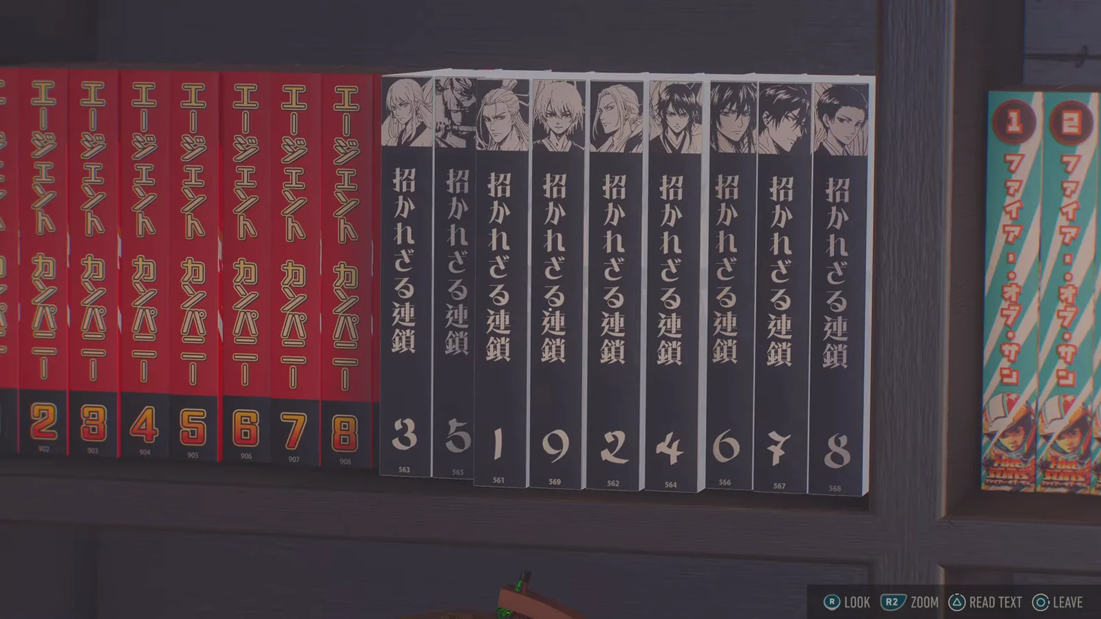 Four manga volumes sit slightly forward of the rest of the row, their numbered spines visible