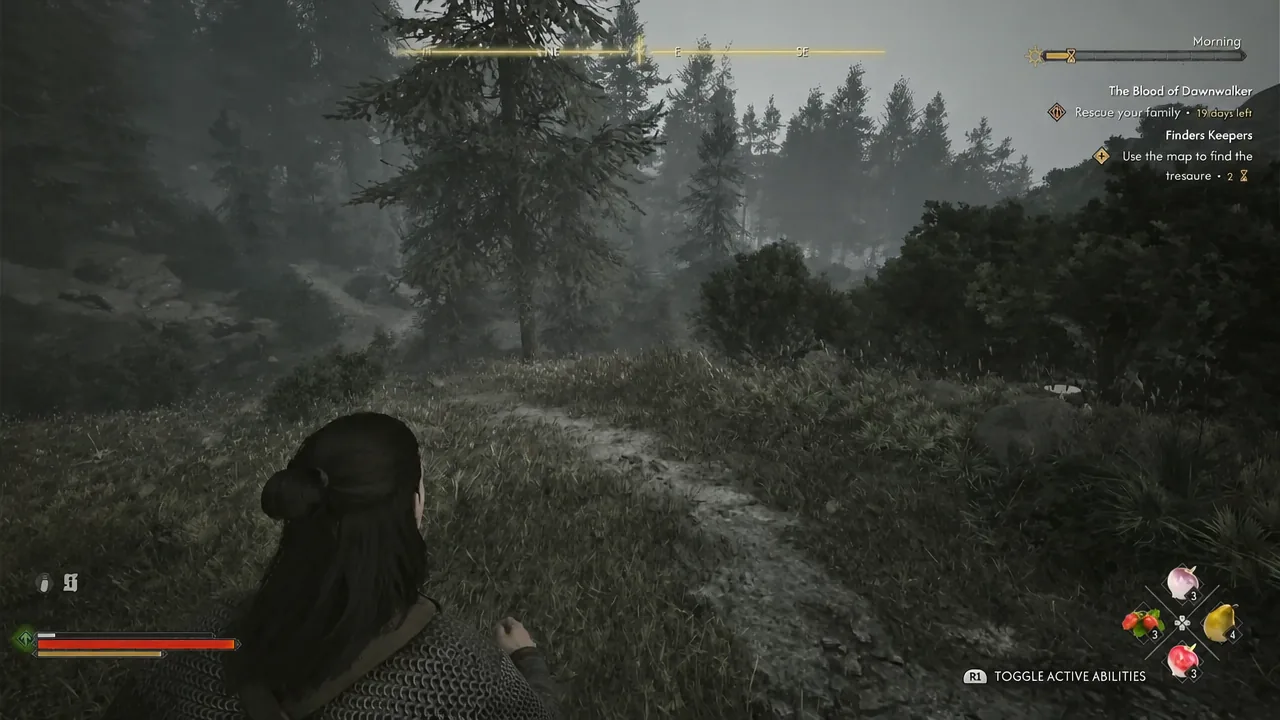 Coen walking a wooded trail with the R1 toggle active abilities prompt on screen
