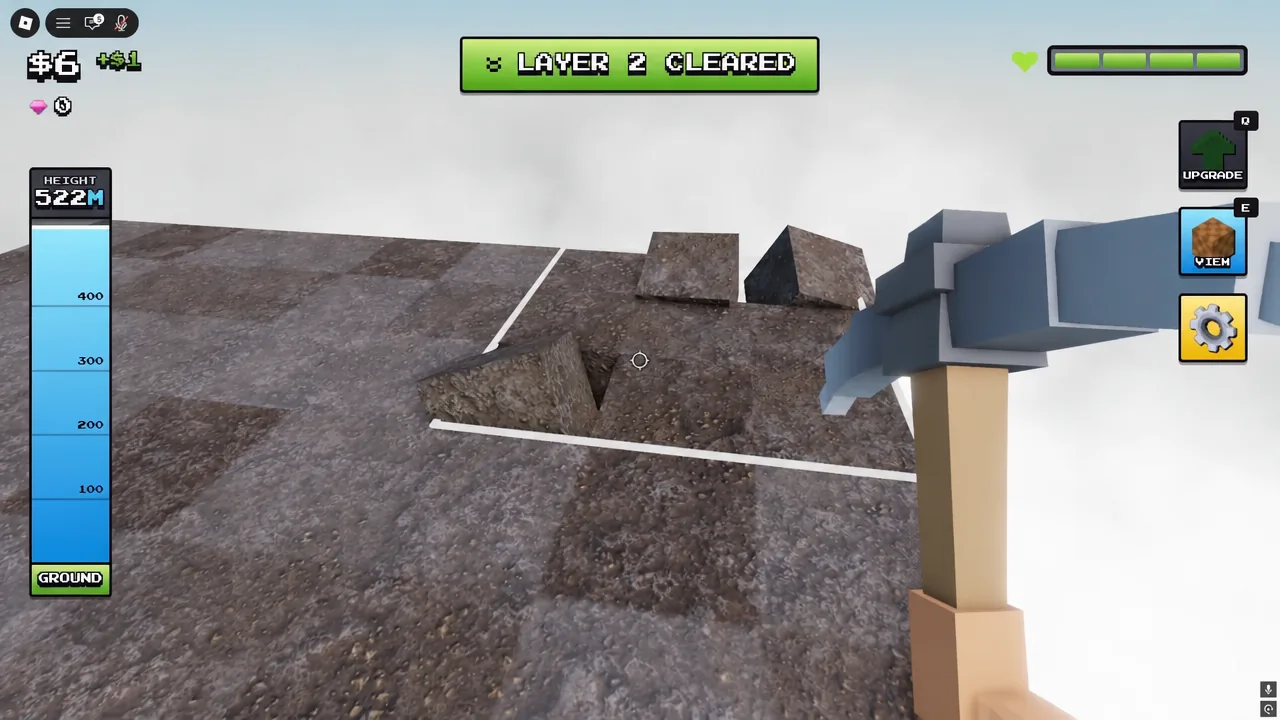 Gameplay screen showing the LAYER 2 CLEARED banner as the pickaxe breaks rocky blocks