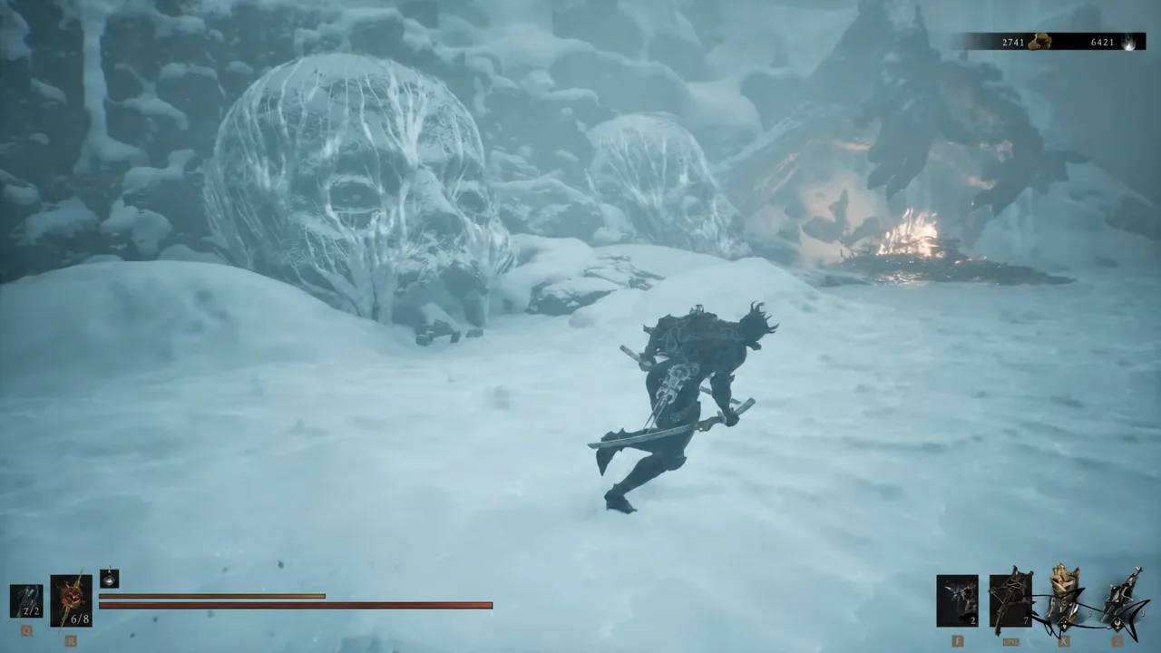 Armored character crossing snow toward giant skull-shaped structures with the HUD visible