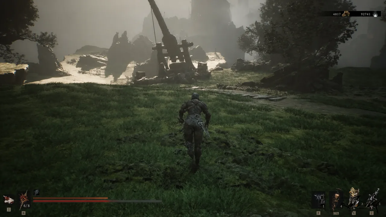 Player sprinting across an open field toward a large siege engine on the way to Sisters' Gate