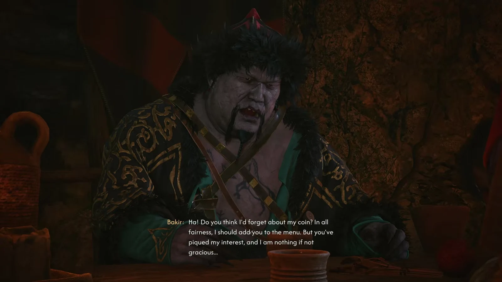 Bakir speaking at the feast table, offering to add the masked contestant to the menu