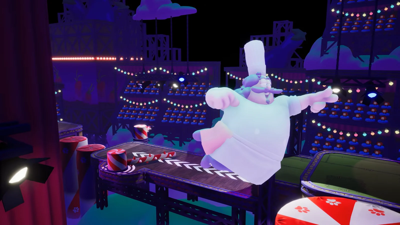 Costumed Garfield jumping across a carnival obstacle course with striped bumpers and rotating barriers