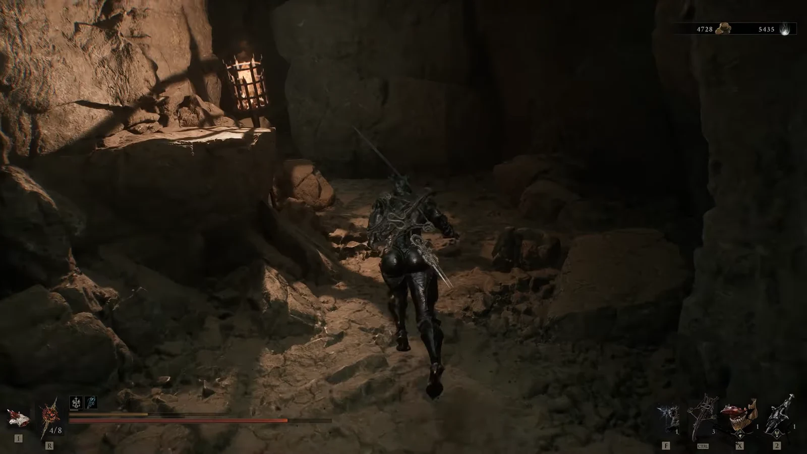 Shell character moving through the torchlit cave corridor with HUD counters visible