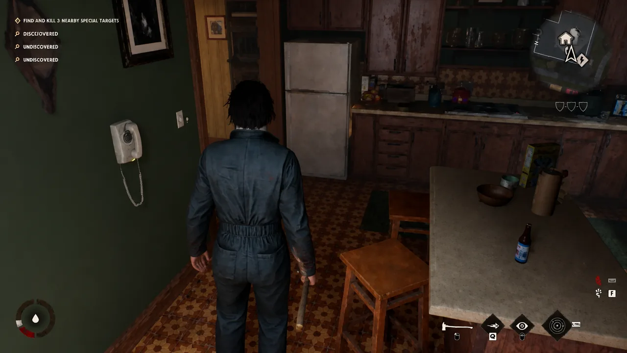 Michael moving through a darkened kitchen with a knife while the special targets objective stays on the HUD