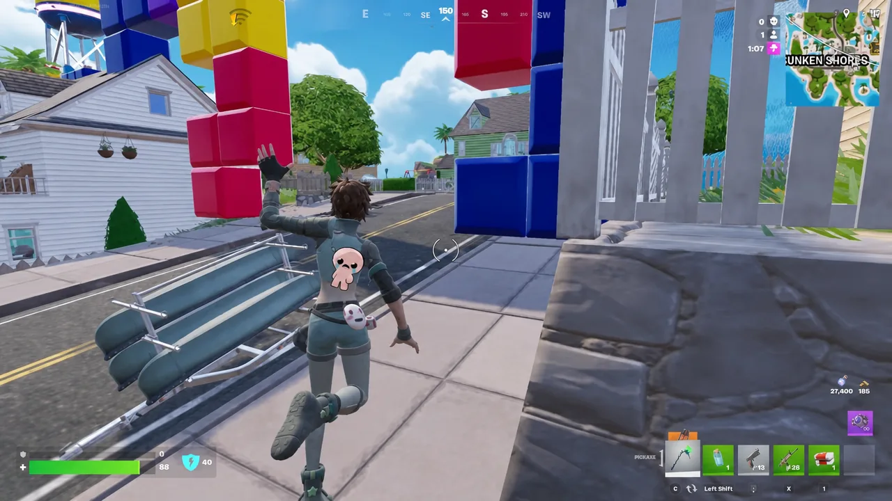 Fortnite player running along a sidewalk with the HUD and inventory visible mid-match