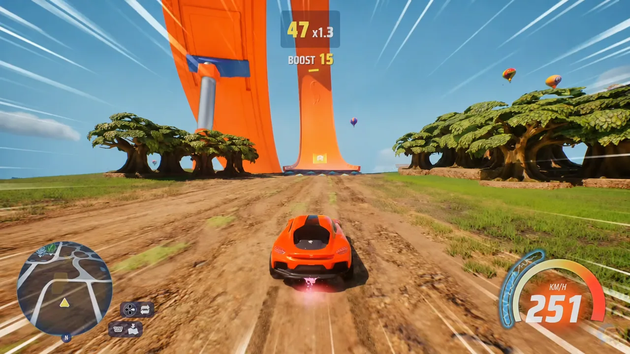 Car boosting in a straight line toward an orange Hot Wheels stunt ramp with a boost indicator on screen