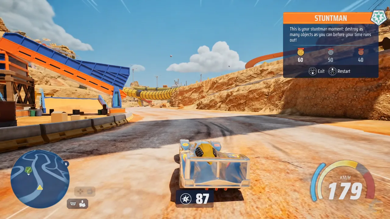 A car driving through Gearville's industrial desert landscape while collecting pickups