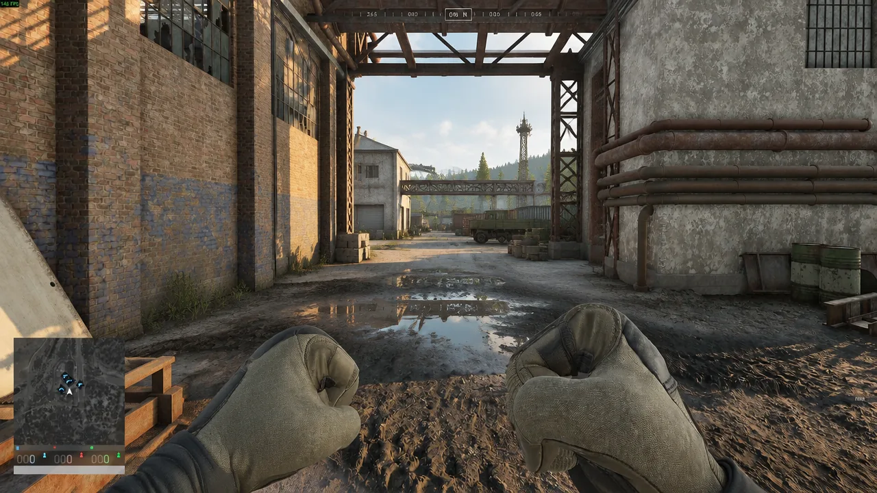 First-person view on foot with gloved fists raised while crossing an industrial yard