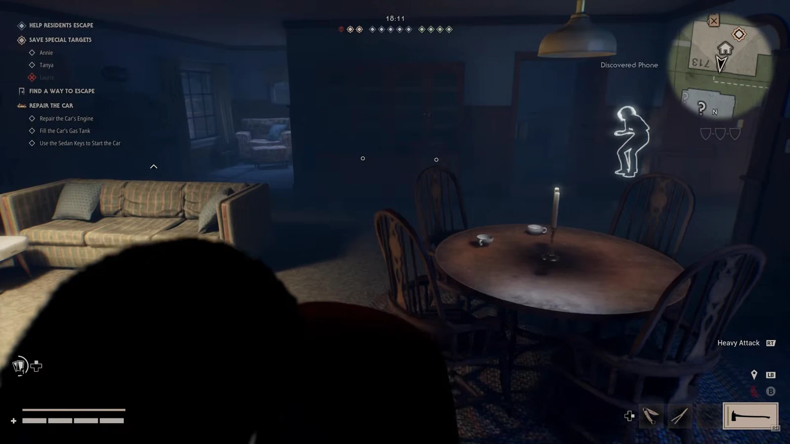Gameplay HUD showing a Discovered Phone notification while searching a room, with the Heavy Attack control visible.