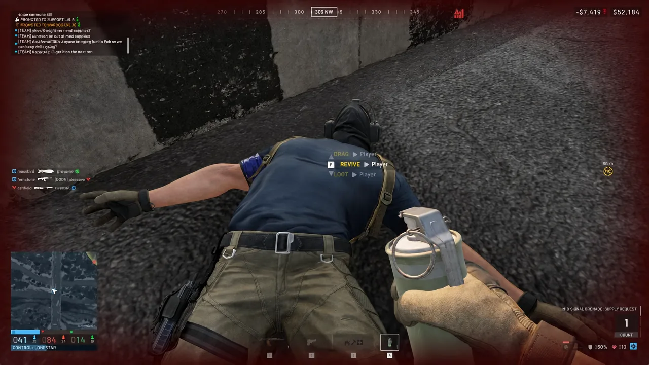 The F REVIVE interaction prompt shown while aiming at a fallen teammate on the ground