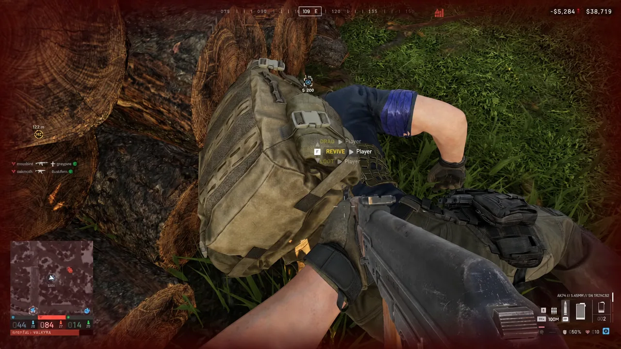 Revive in progress on a downed player with the F REVIVE prompt highlighted on screen