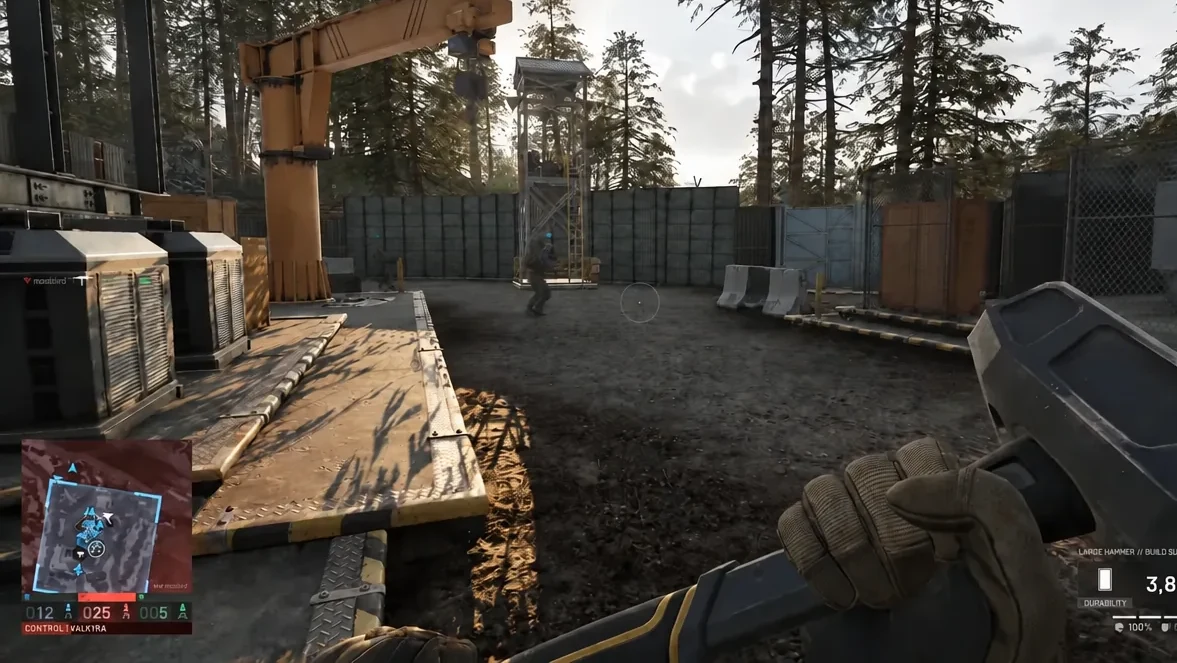 First-person view with the Large Hammer equipped, crosshair lined up on a distant enemy