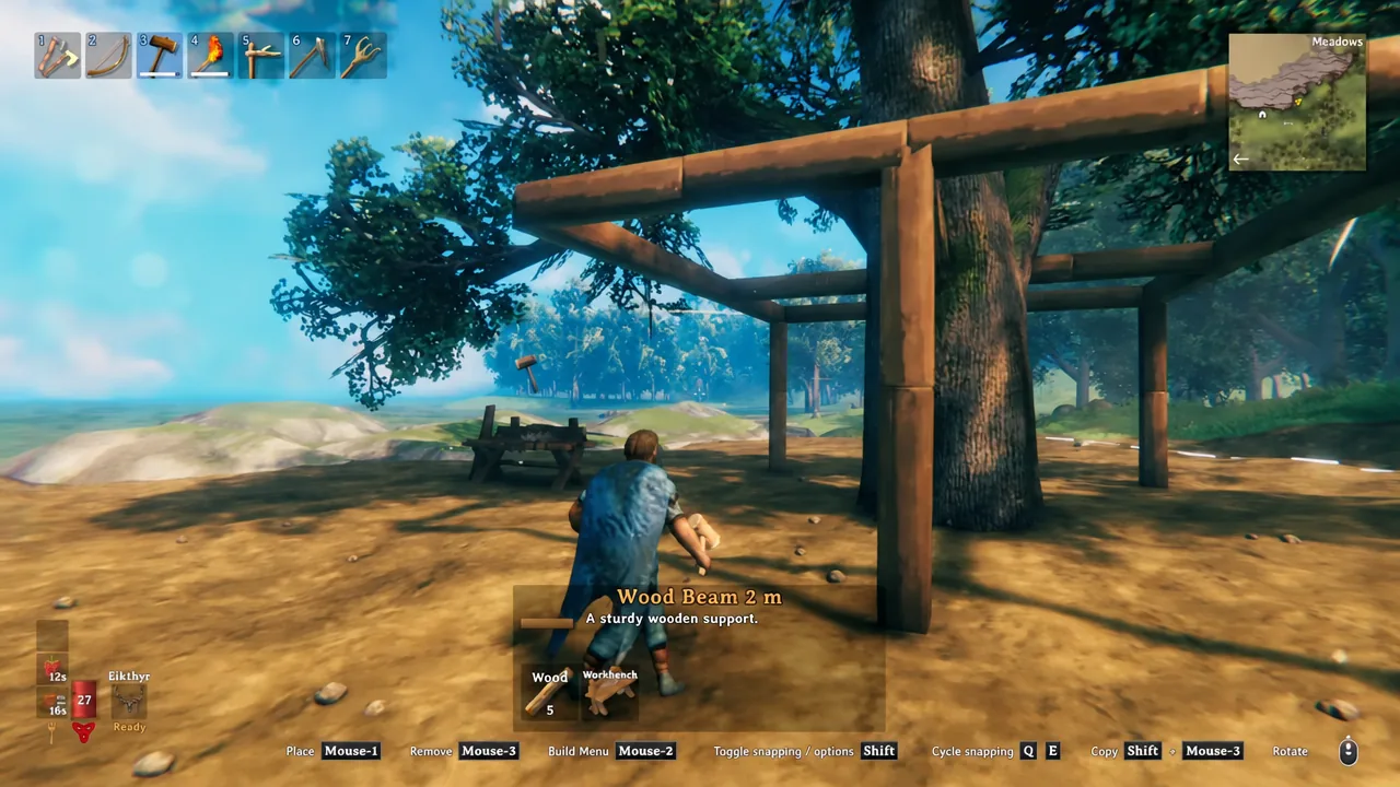 Build mode with Wood Beam 2 m selected and a green placement preview against the tree