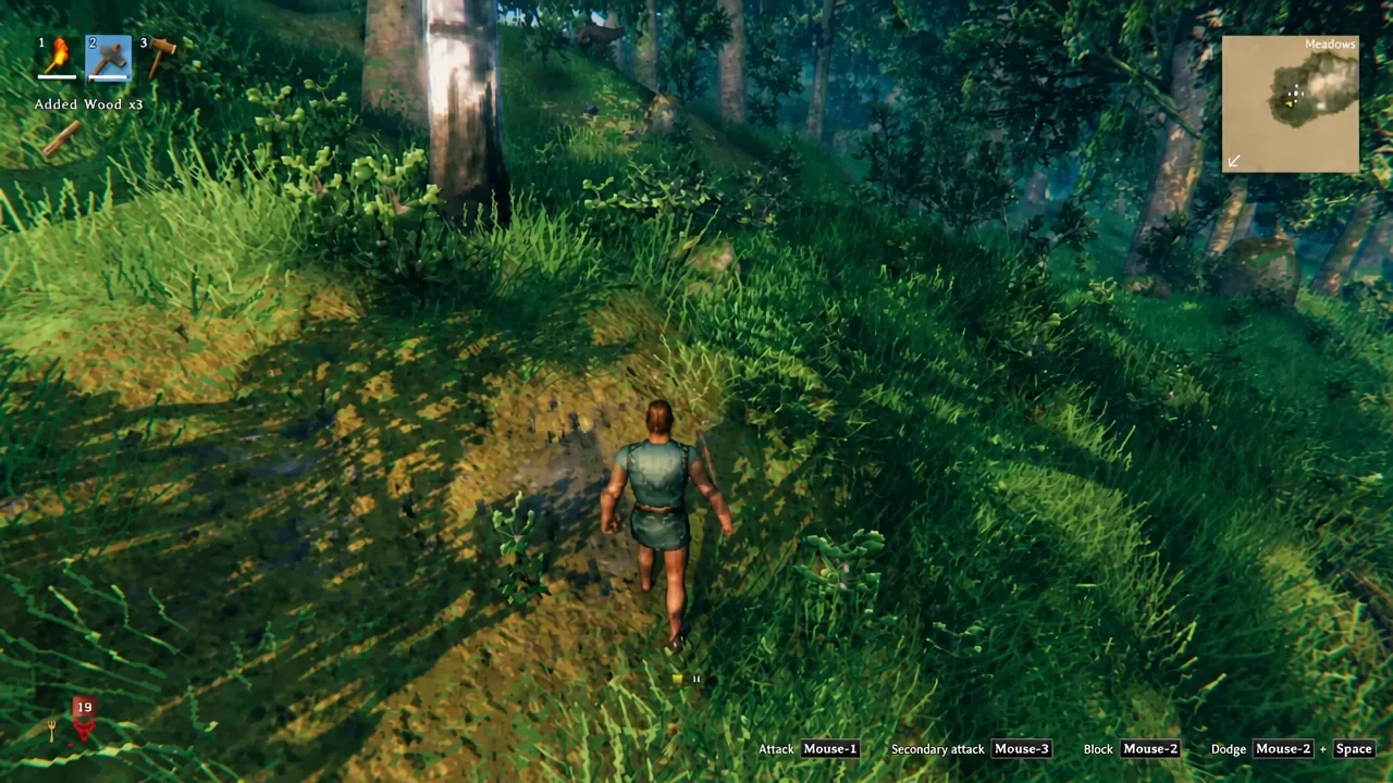 Player walking through the Meadows with an axe in hotbar slot 2 after picking up three wood