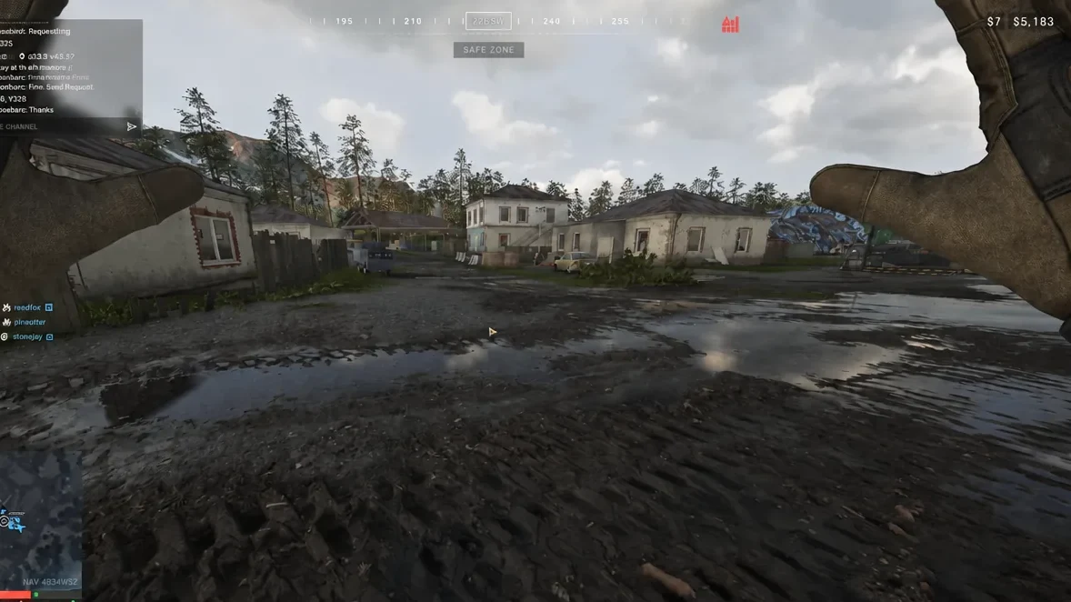 First-person view of a muddy village courtyard with the SAFE ZONE marker at the top of the HUD