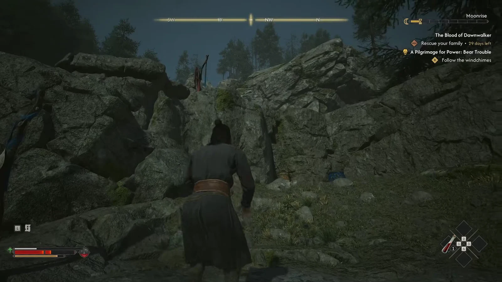 Coen crossing broken rock near the summit with the Bear Trouble objective tracked on screen