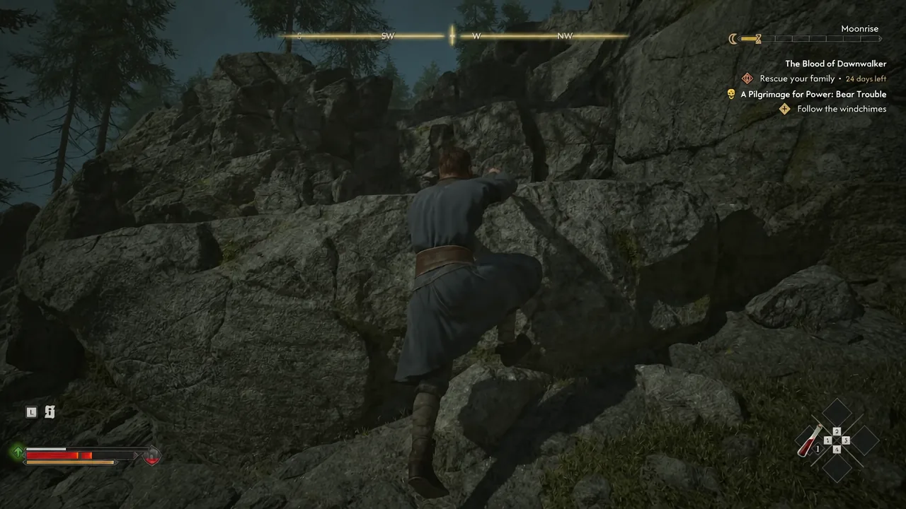 Coen scaling the rock face below the first windchime with the objective marker visible