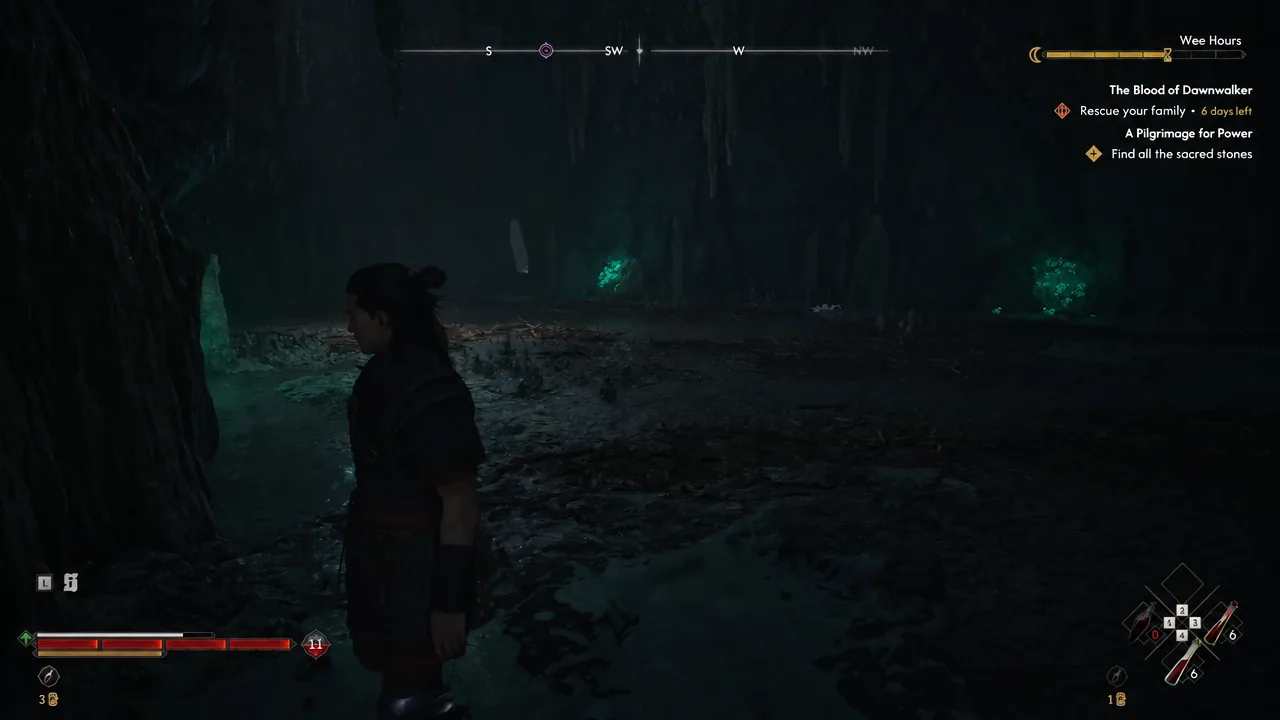 Inside the dark unmarked cave with the quest tracker showing while the character explores the passage