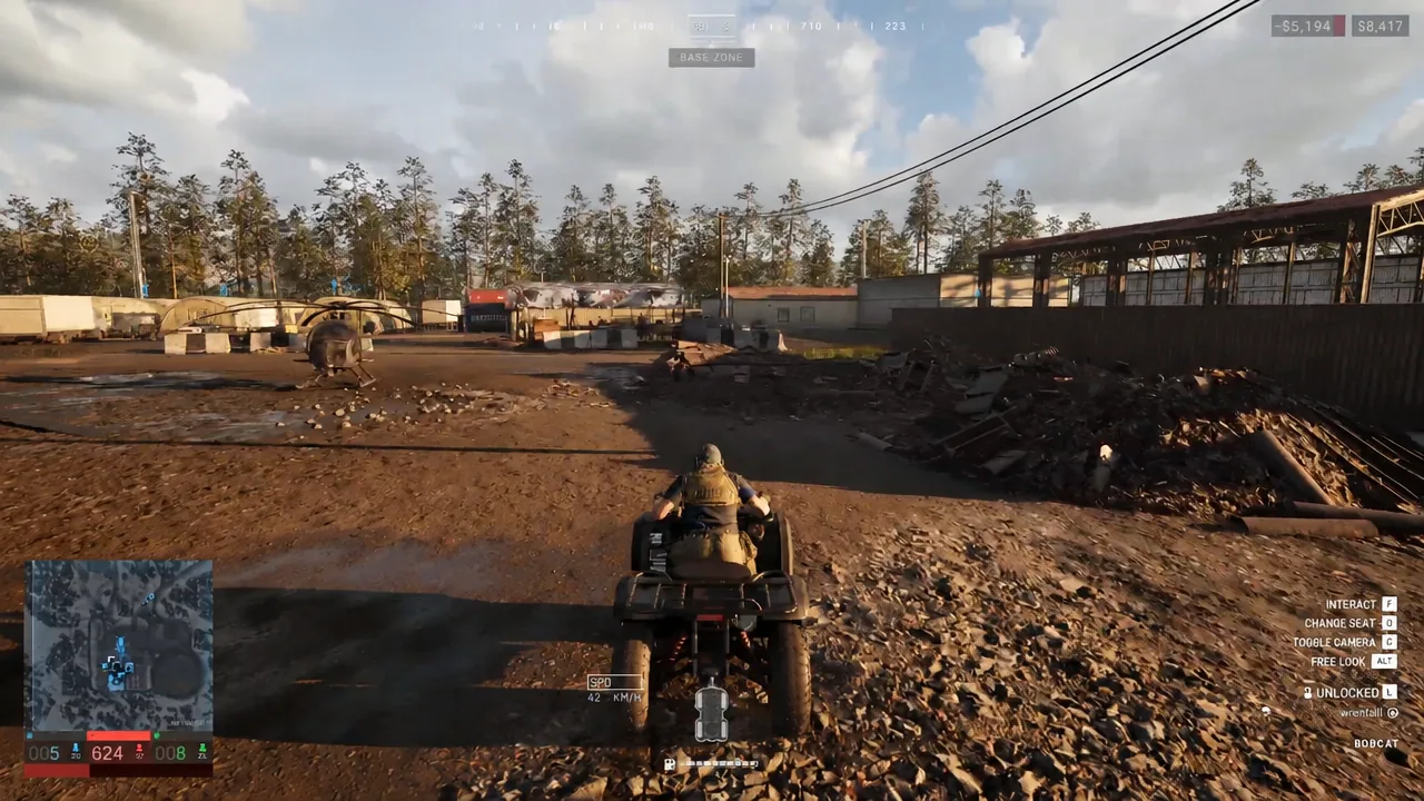 Driving a quad bike through the base zone with the vehicle control prompts shown at bottom right