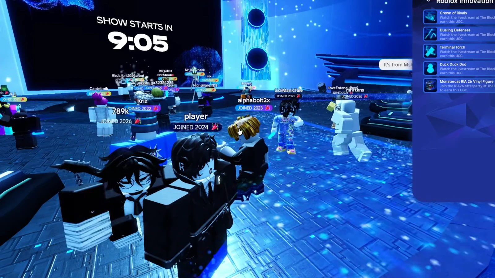 Countdown reading SHOW STARTS IN 9:05 above the stage as players wait in the event lobby