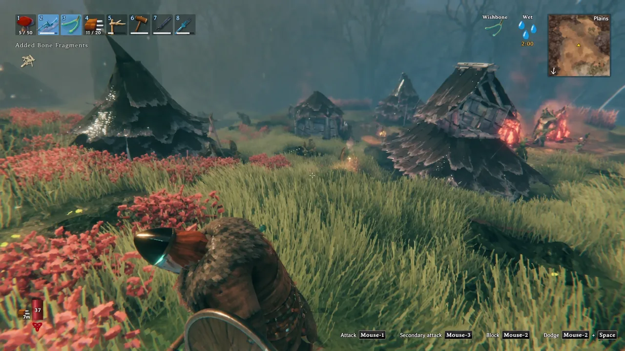Player standing among burning Fuling huts as the HUD shows Bone Fragments added