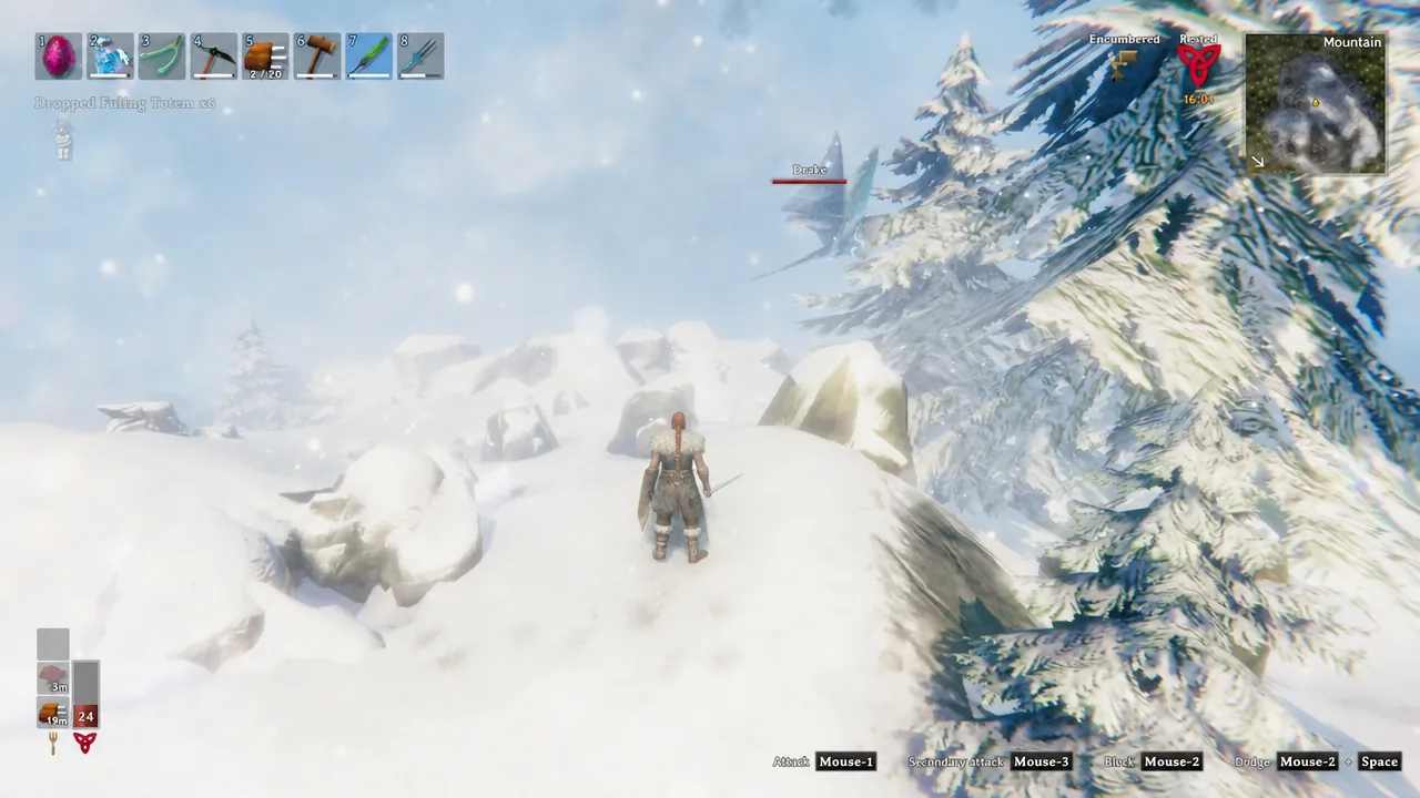 Player character facing a Drake on a snowy Mountain slope with the attack prompt on screen