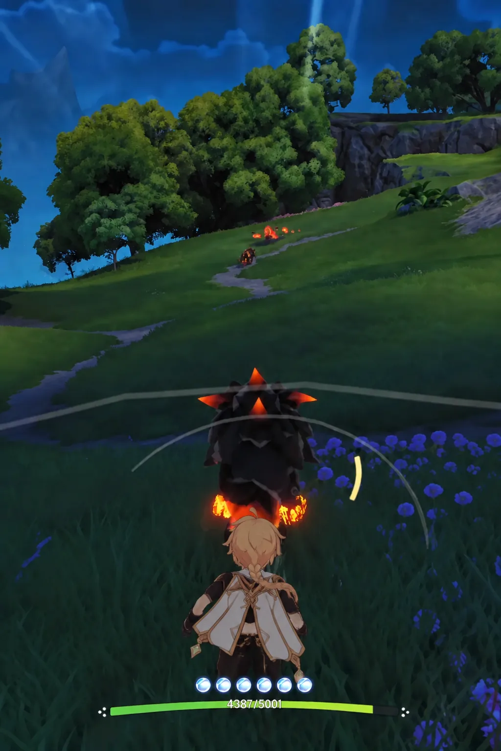 Closing in on a flaming creature on a Nimbus Fields hillside during combat