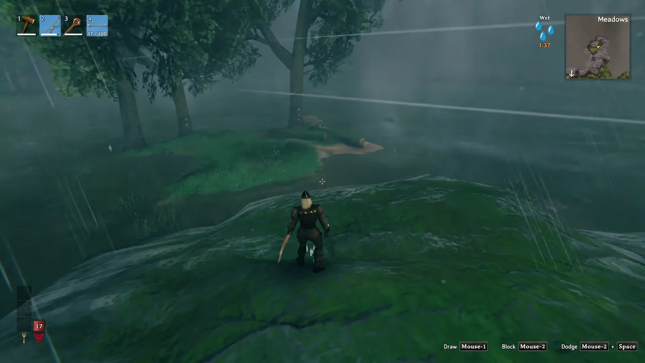 Rainy Meadows shoreline with the hotbar quick-slot highlighted during a storm