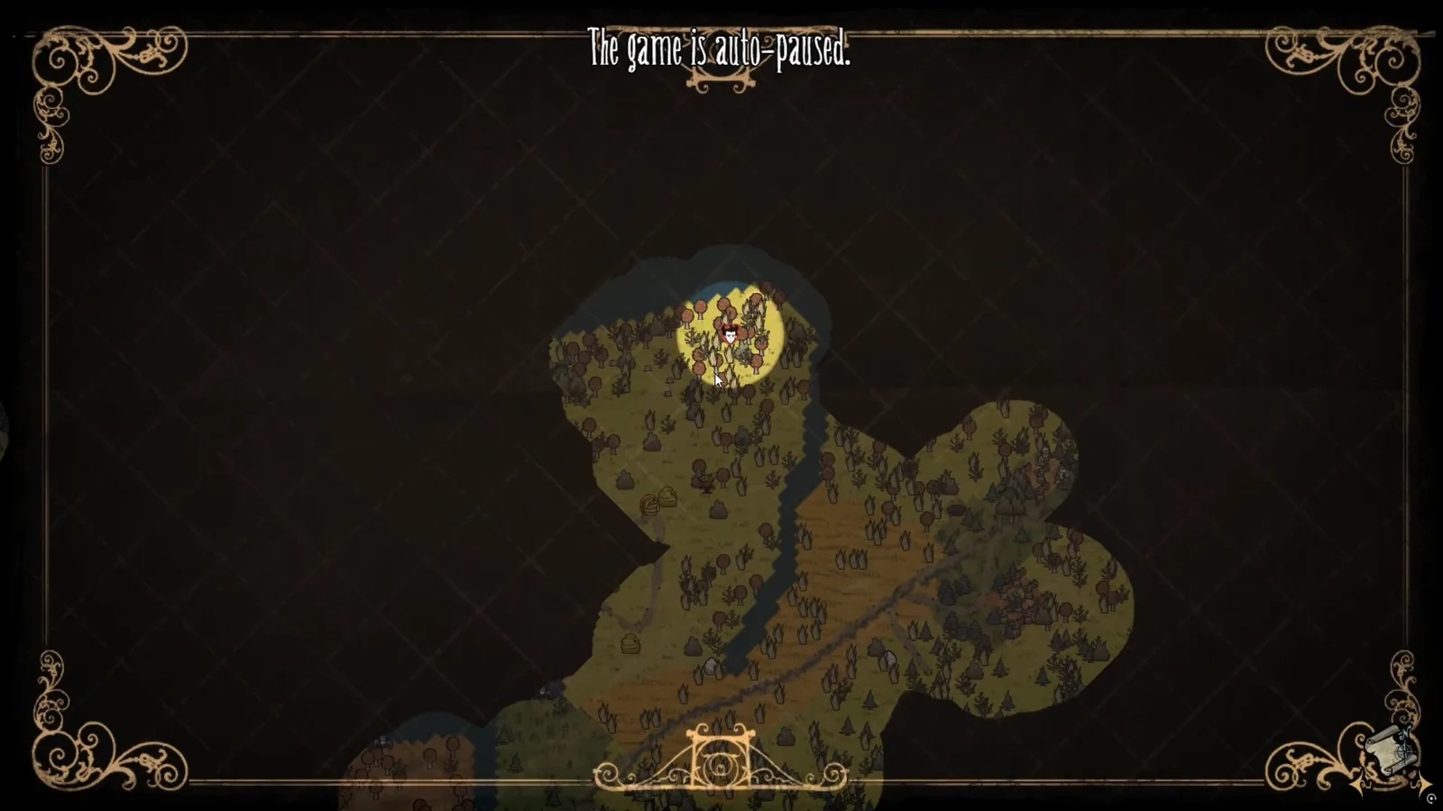 The world map open and auto-paused, with the player marker shown among explored terrain