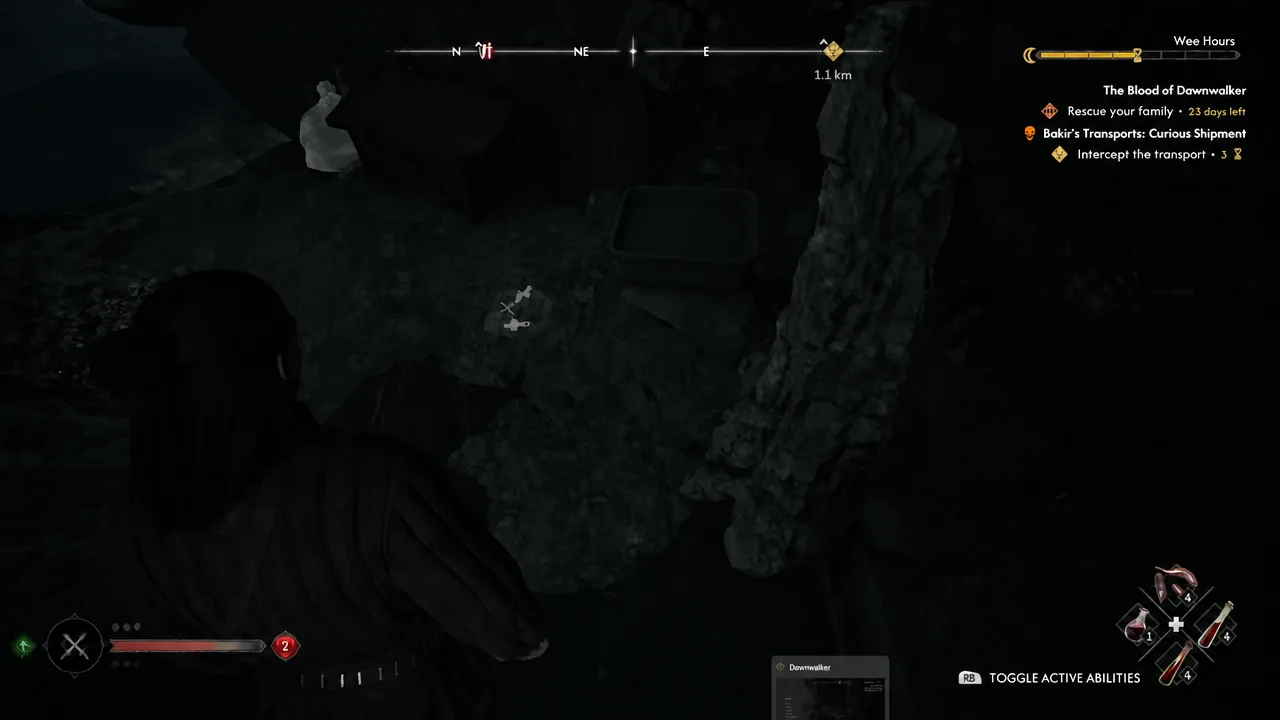 Dark cavern interior behind the waterfall with an interactable prompt glowing ahead of the player